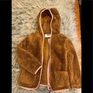 chocolate brown fuzzy jacket with pink trimmings.